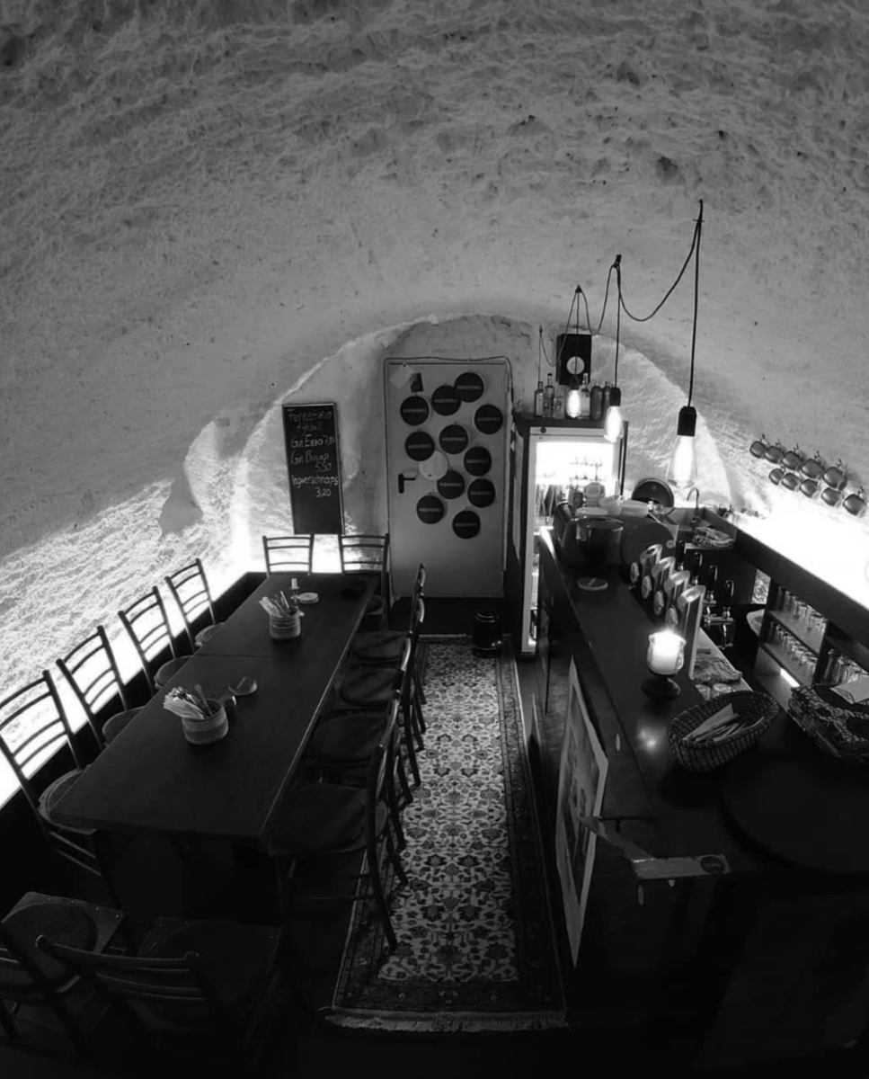 Blick in das Kellergewölbe des tamu sana mit langer Tafel und Bar